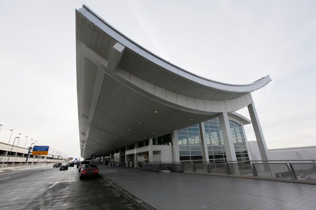 Car crashes through terminal entrance at Detroit airport, injuring six
