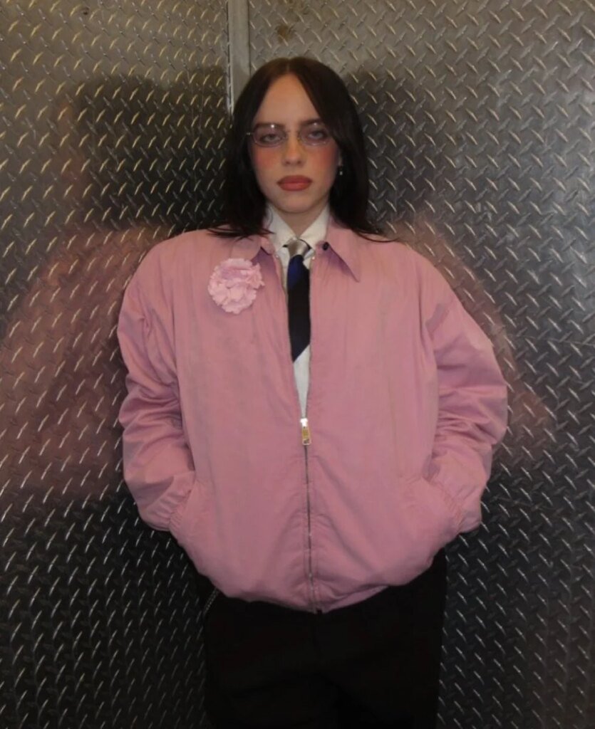 Billie Eilish Shares New Photo In Pink Bomber Jacket And Black Tie