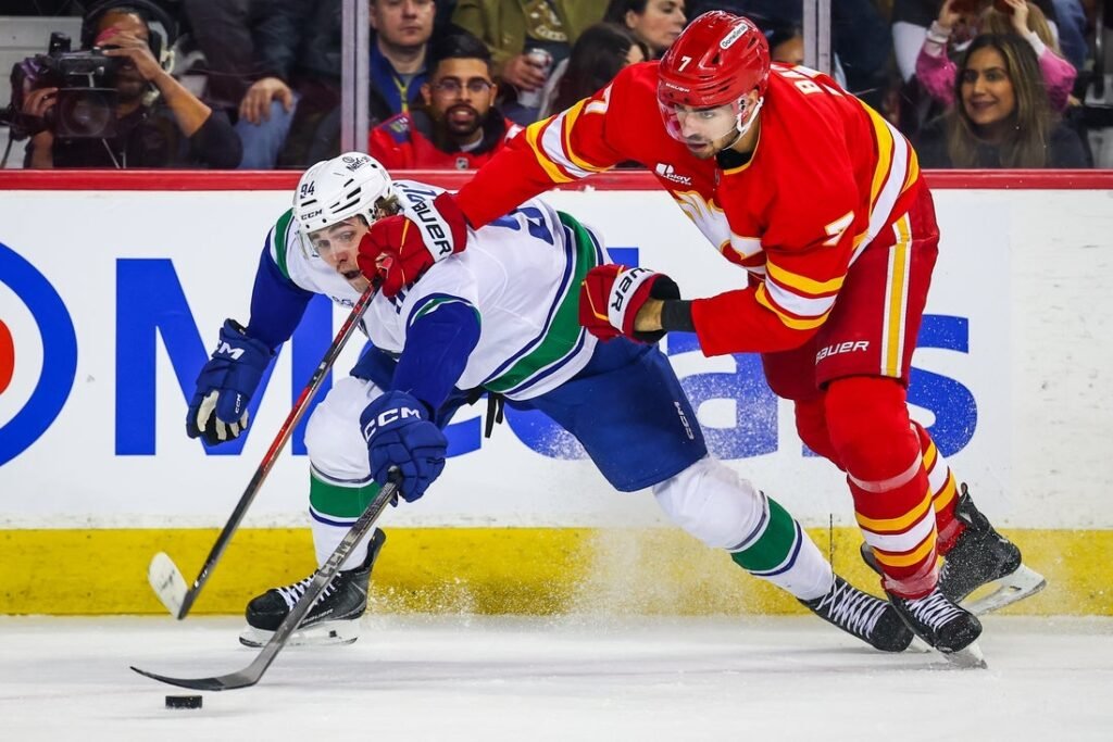 Flames remain hot, beat up on Canucks