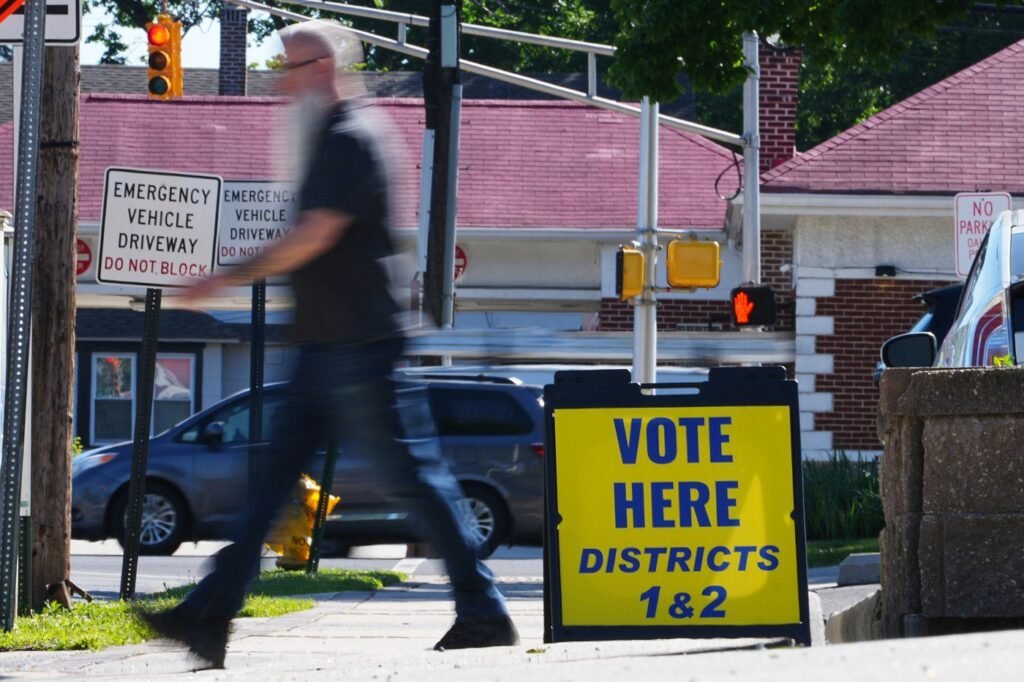 The Latest: Polls open for races across the US as a busy primary election day gets underway