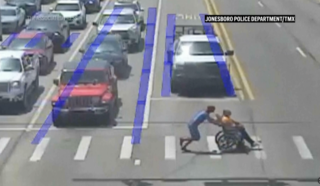 Spider-Man moonlights as good Samaritan, guides man in wheelchair across long crosswalk in Arkansas Spider-Man moonlights as good Samaritan, guides man in wheelchair across long crosswalk in Arkansas