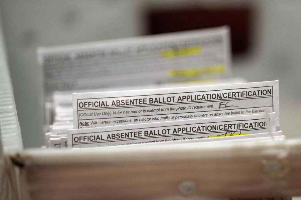 Wisconsin voters begin casting ballots at the polls in chaotic Democratic governor's race